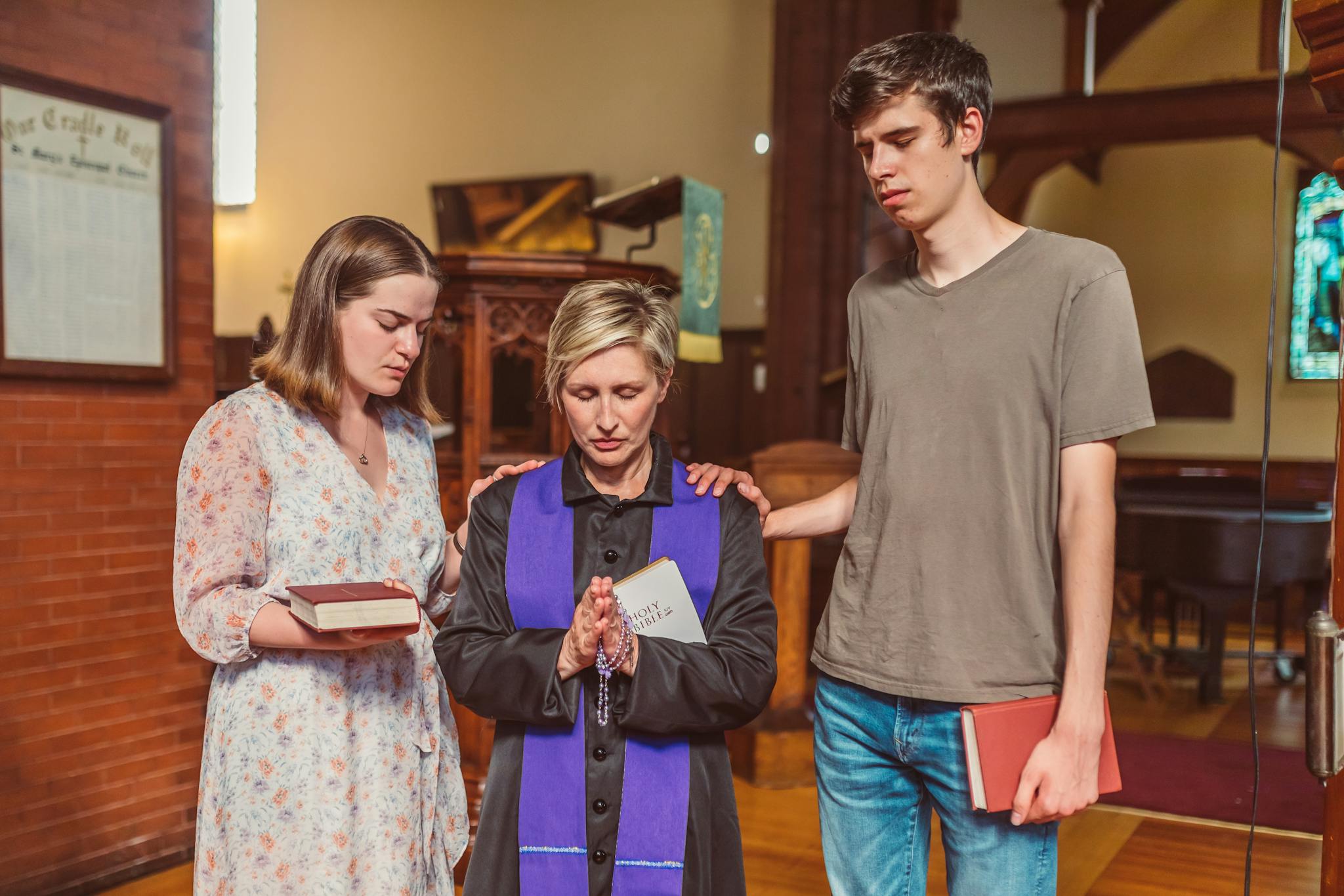 Group of people praying in a church setting, showcasing faith and spirituality.